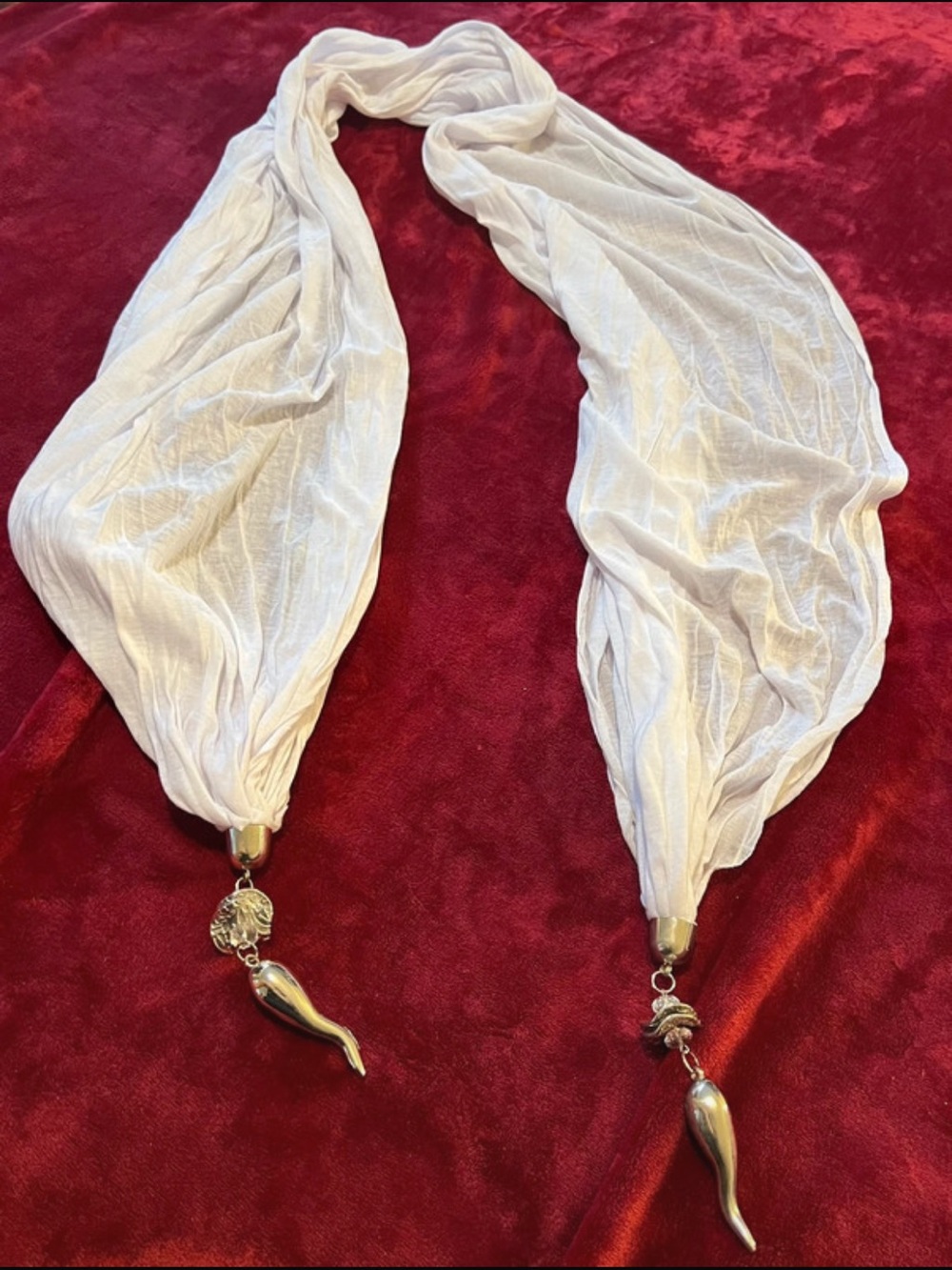 White stretchy scarf with rhinestone accents and dangling silver charms